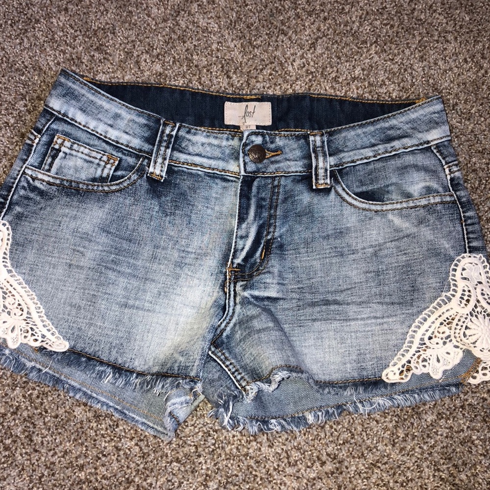 Jean shorts with lace embroidering on side